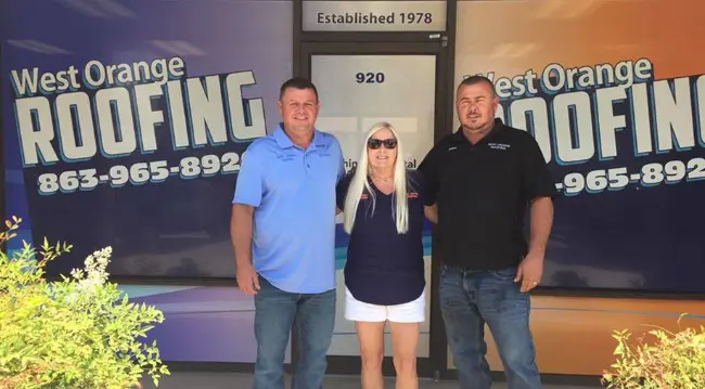 Three West Orange Roofing team members standing in front of the office