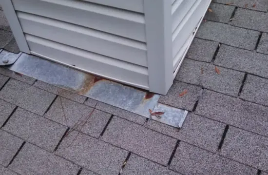 Damaged flashing on a roof causing water to leak into the roof boards