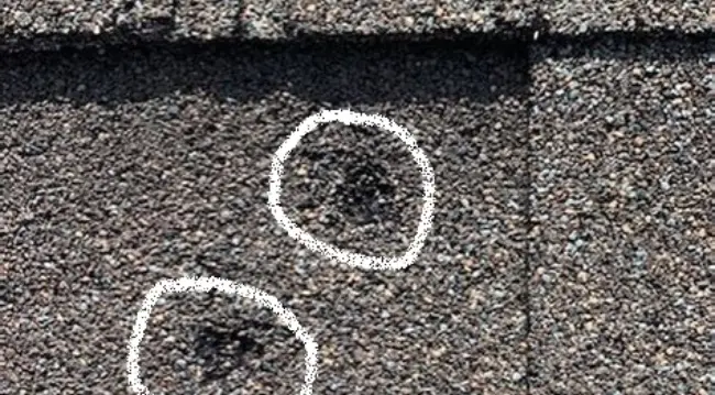 Close up of hail damaged asphalt shingle