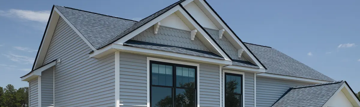 A home in Florida with a new gray asphalt shingle roof installed by West Orange Roofing